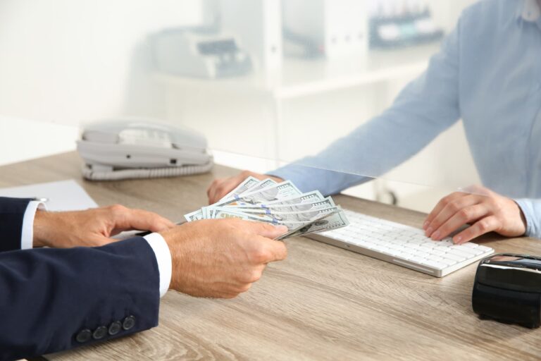 Man giving money to teller.